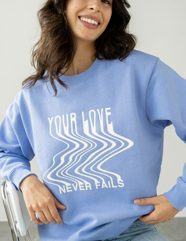 Love Never Fails Blue Unisex Crewneck Christian Sweatshirt